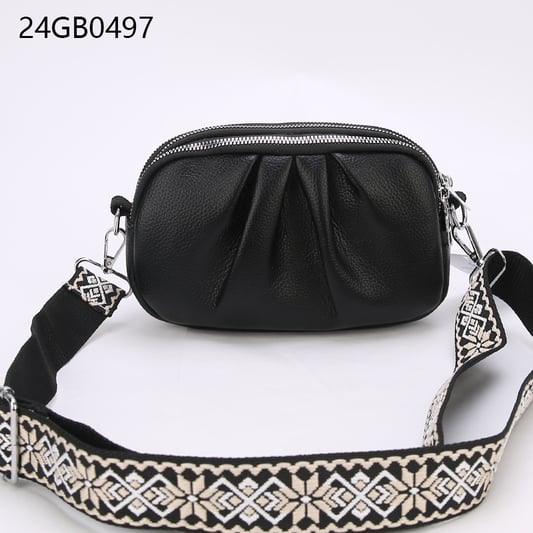 Faux leather cross body bag with patterned shoulder strap